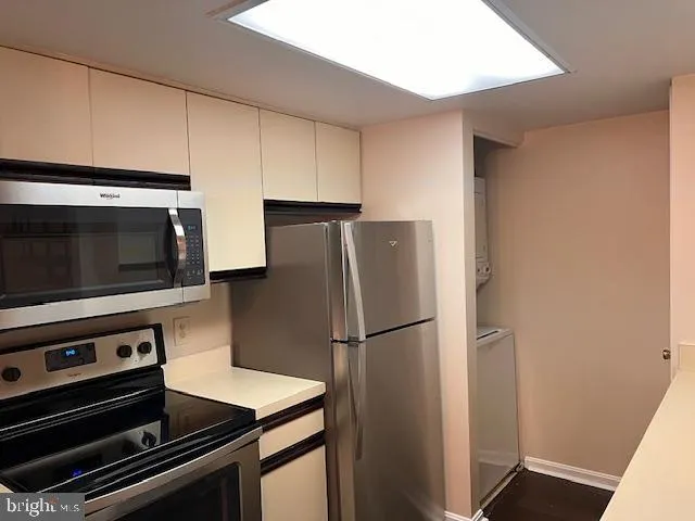 a kitchen with appliances and a refrigerator