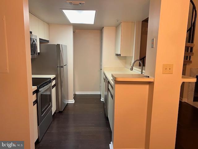 14119 Bowsprit Lane, Unit 312 Laurel, MD 20707 - Photo 10 of 24 a kitchen with a refrigerator and a sink