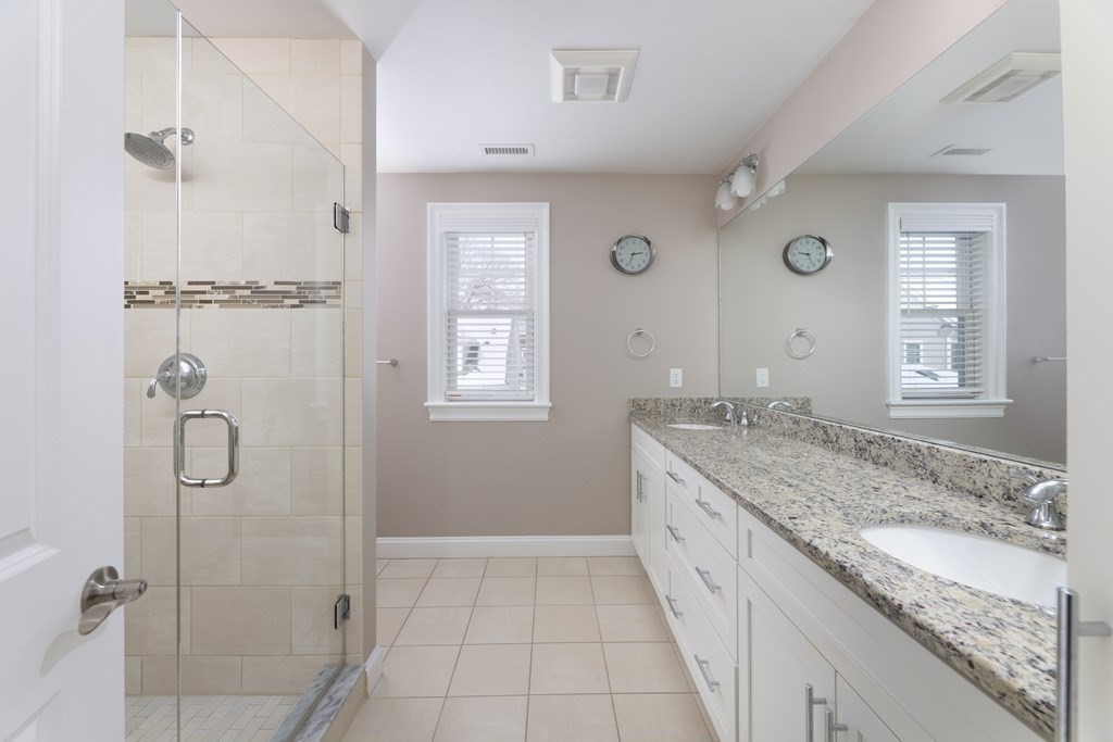 55 Kendall Road Lexington, MA 02421 - Photo 13 of 32 a spacious bathroom with a granite countertop sink a mirror and a shower