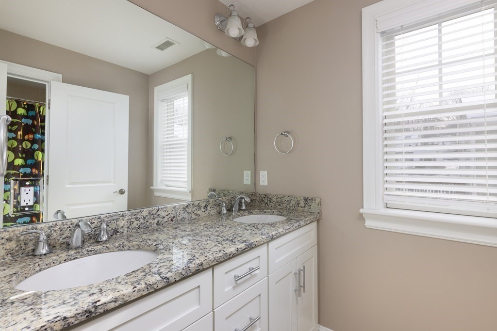 55 Kendall Road Lexington, MA 02421 - Photo 17 of 32 a bathroom with a granite countertop sink and a mirror