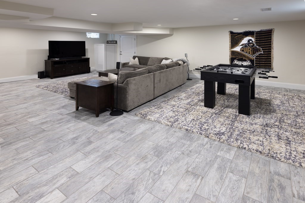 55 Kendall Road Lexington, MA 02421 - Photo 21 of 32 a living room with furniture a flat screen tv and a fireplace