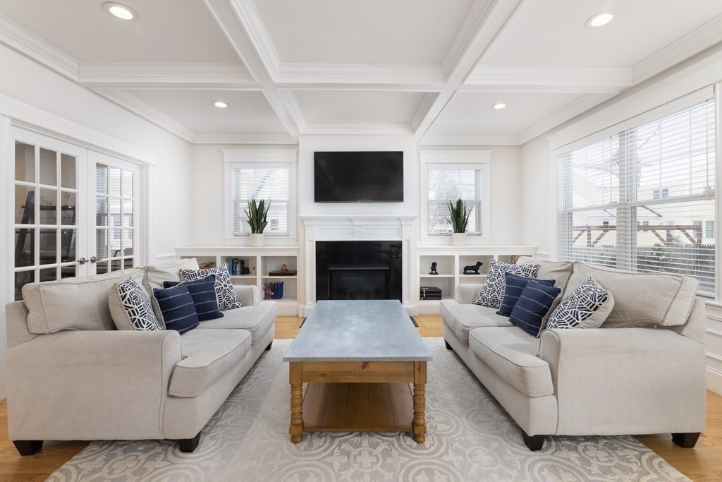 55 Kendall Road Lexington, MA 02421 - Photo 10 of 32 a living room with furniture a flat screen tv and a fireplace