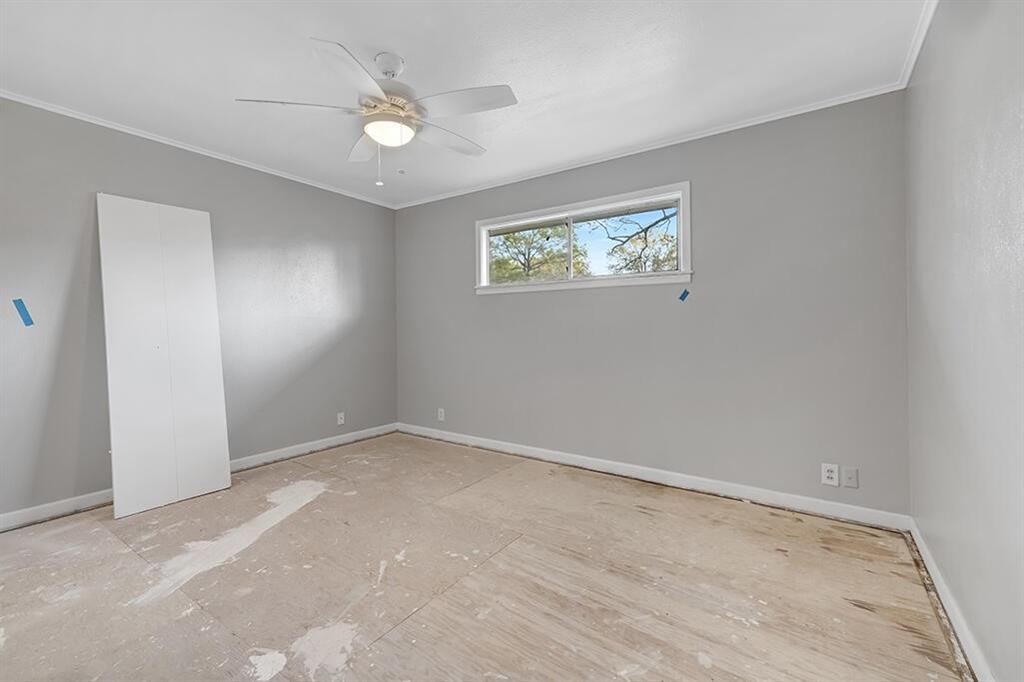 2305 Cherry Hill Road Texarkana, TX 75503 - Photo 11 of 20 an empty room with a ceiling fan and window
