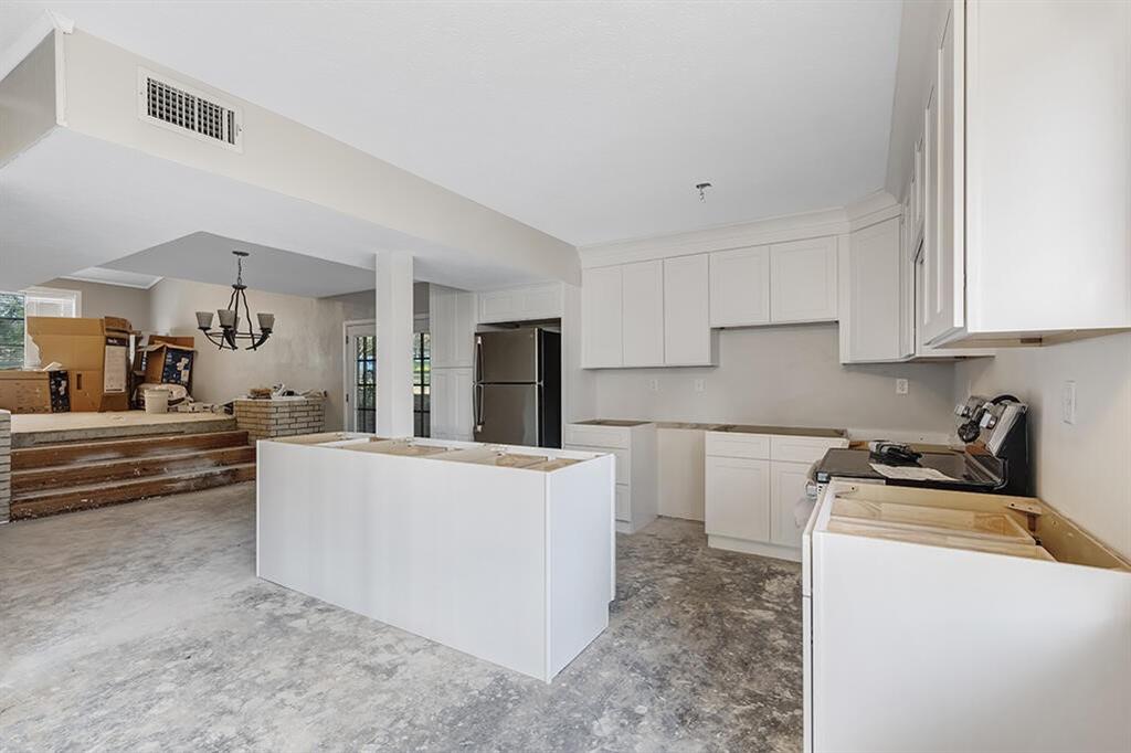 2305 Cherry Hill Road Texarkana, TX 75503 - Photo 7 of 20 a living room with stainless steel appliances kitchen island a sink a stove a refrigerator cabinets and a counter top space