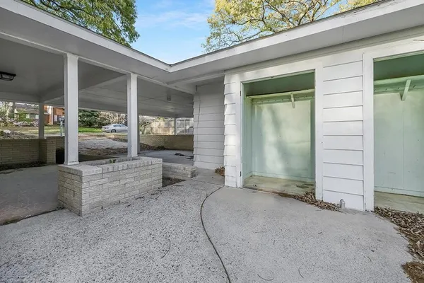 a view of a porch with furniture and floor to ceiling window