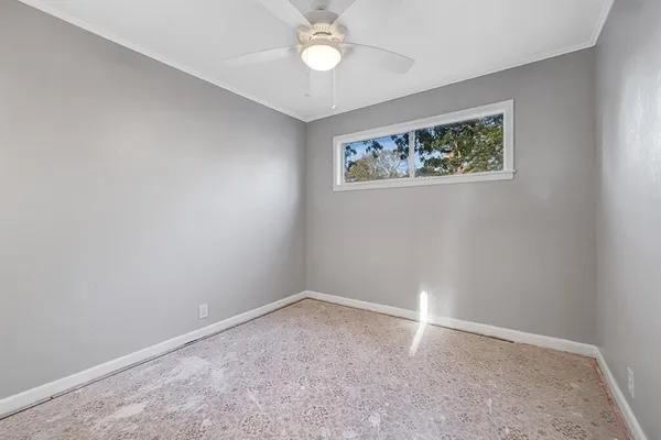 an empty room with a fan