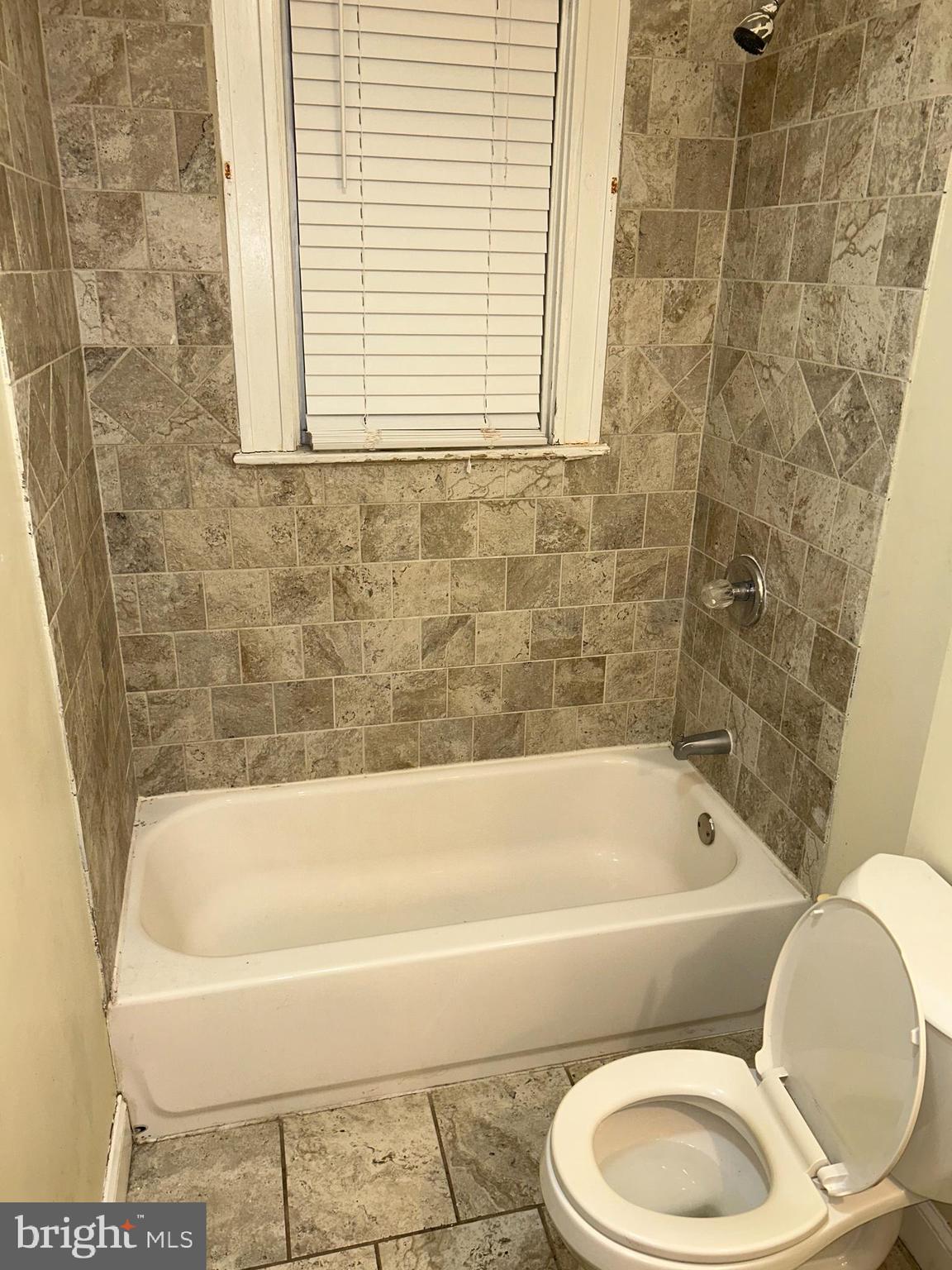3203 Kenyon Avenue Baltimore, MD 21213 - Photo 16 of 28 a bathroom with a toilet bathtub and shower