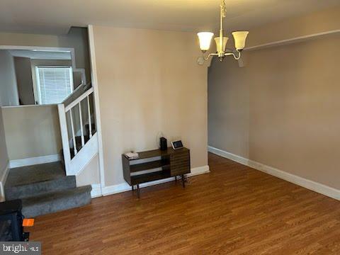 3203 Kenyon Avenue Baltimore, MD 21213 - Photo 2 of 28 a view of an empty room with wooden floor and a window