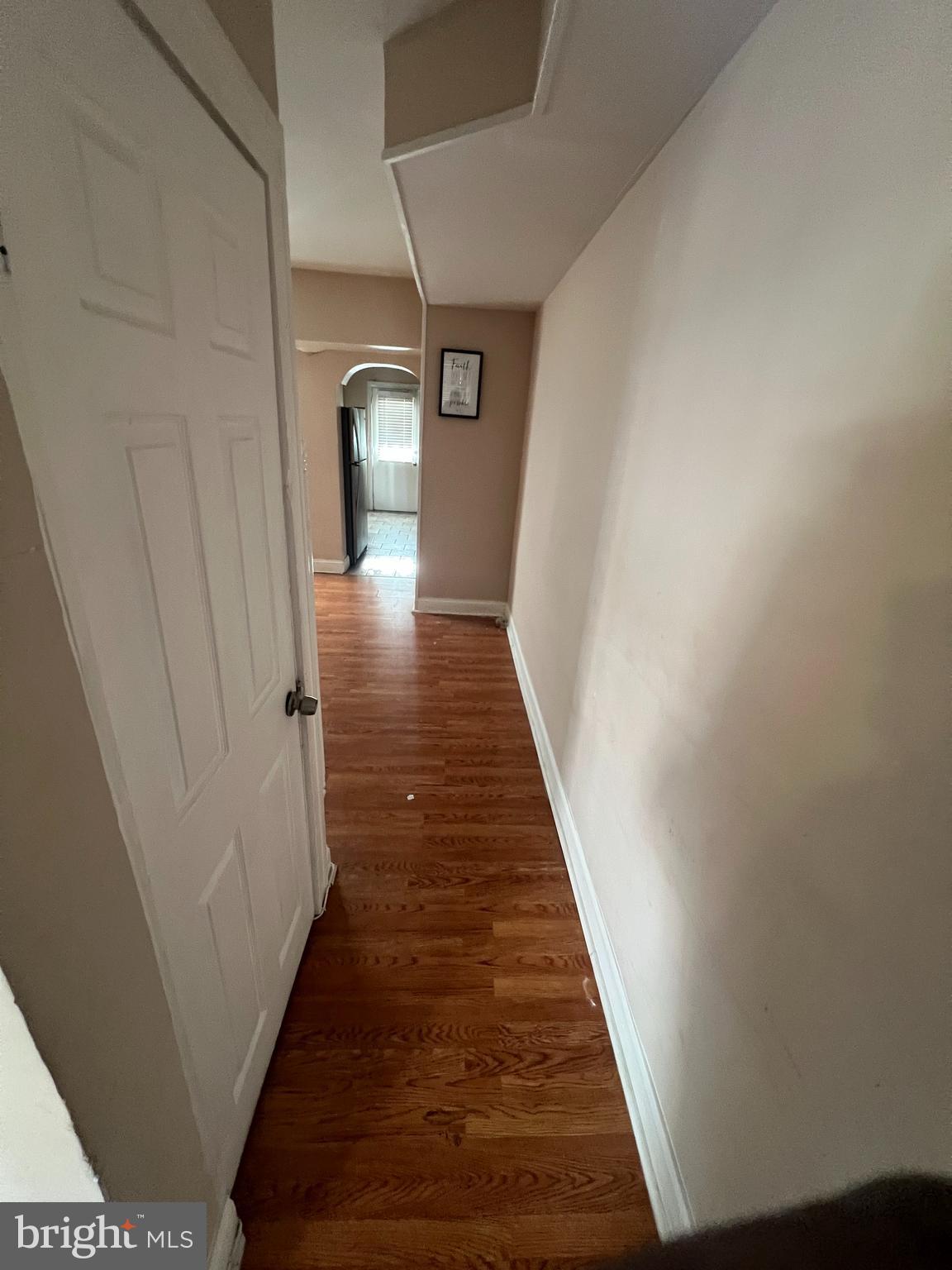 3203 Kenyon Avenue Baltimore, MD 21213 - Photo 4 of 28 a view of a hallway with wooden floor and staircase