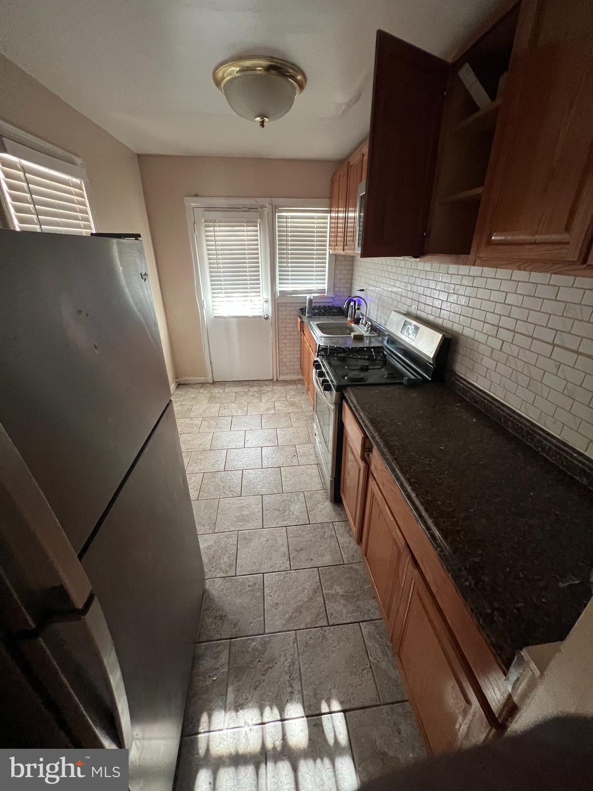 3203 Kenyon Avenue Baltimore, MD 21213 - Photo 7 of 28 a kitchen with a stove and a refrigerator