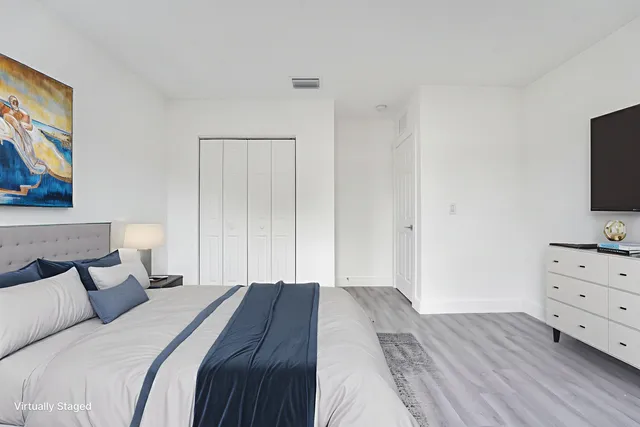 a bedroom with a bed and a dresser