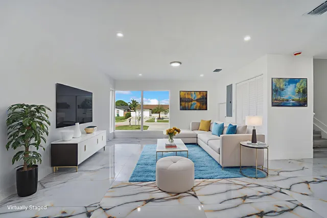 a living room with fireplace furniture and a flat screen tv