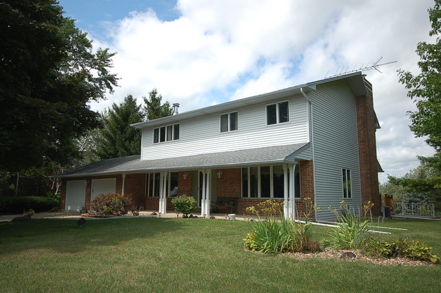 44W482 Ramm Road Maple Park, IL 60151 - Photo 1 of 25 a front view of a house with a garden