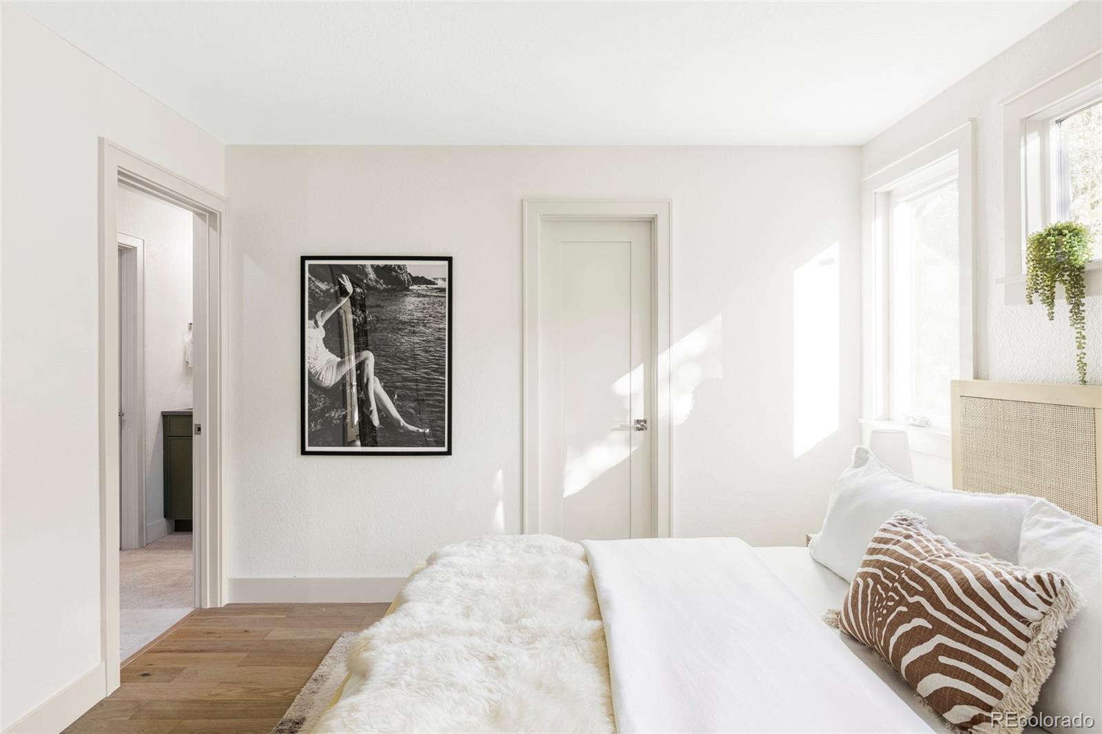 1380 Ithaca Drive Boulder, CO 80305 - Photo 14 of 34 a bedroom with a bed and a painting on the wall