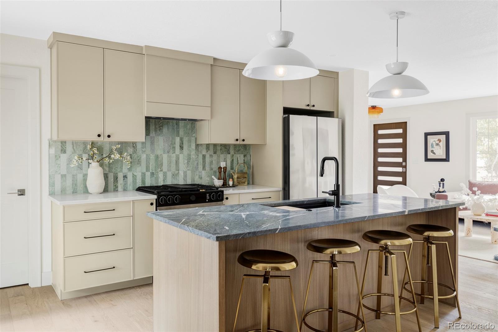 1380 Ithaca Drive Boulder, CO 80305 - Photo 9 of 34 a kitchen with granite countertop a table chairs stove and cabinets
