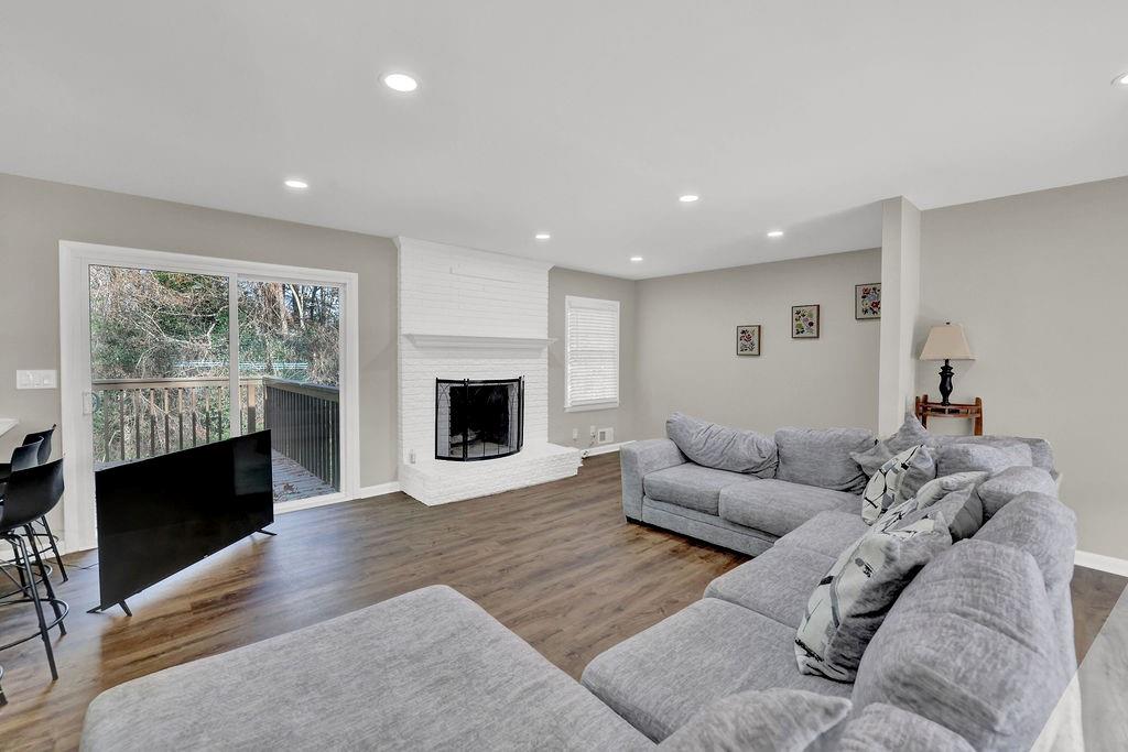 4420 Lavista Road Tucker, GA 30084 - Photo 12 of 36 a living room with furniture a fireplace and a flat screen tv