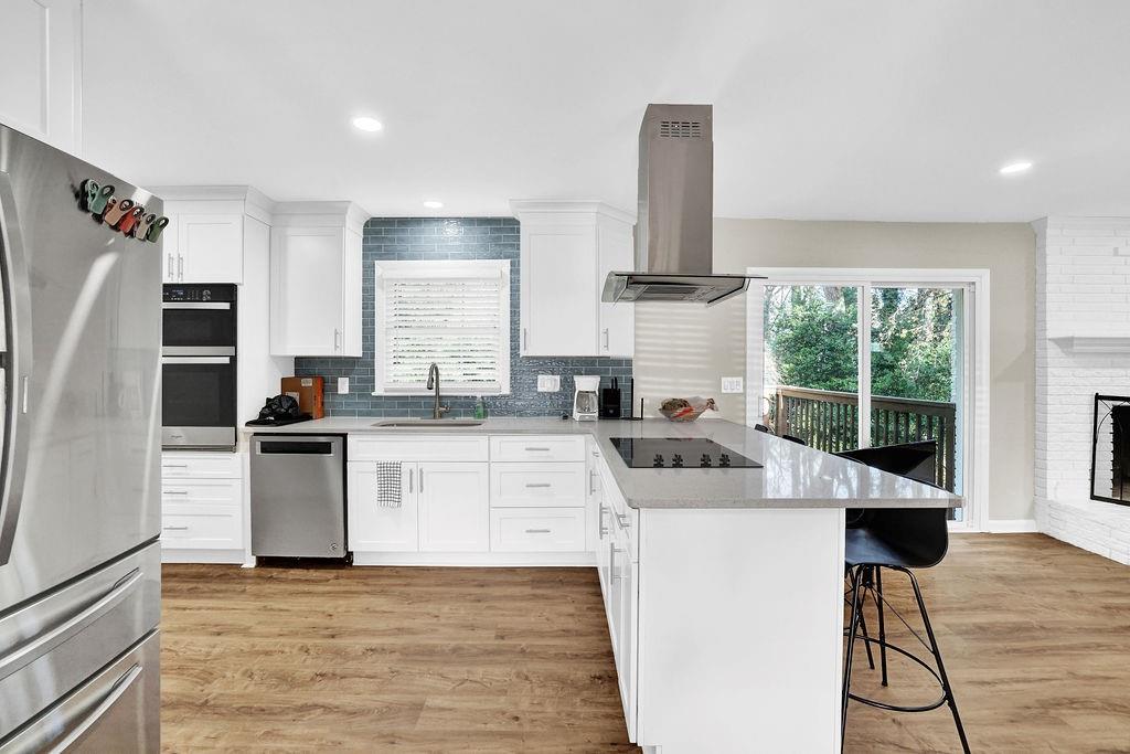 4420 Lavista Road Tucker, GA 30084 - Photo 14 of 36 a kitchen with stainless steel appliances kitchen island granite countertop a refrigerator stove and sink