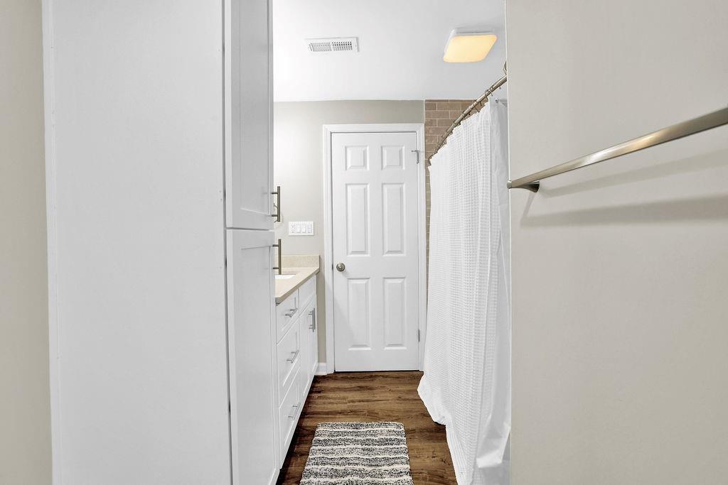 4420 Lavista Road Tucker, GA 30084 - Photo 32 of 36 a view of a hallway with white walls and wooden floor