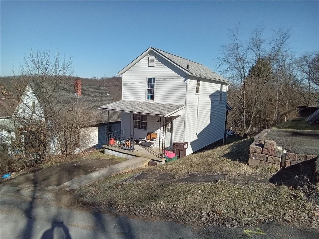 133 Slagle Avenue Butler, PA 16001 - Photo 2 of 14 a view of a white house with a yard and sitting area