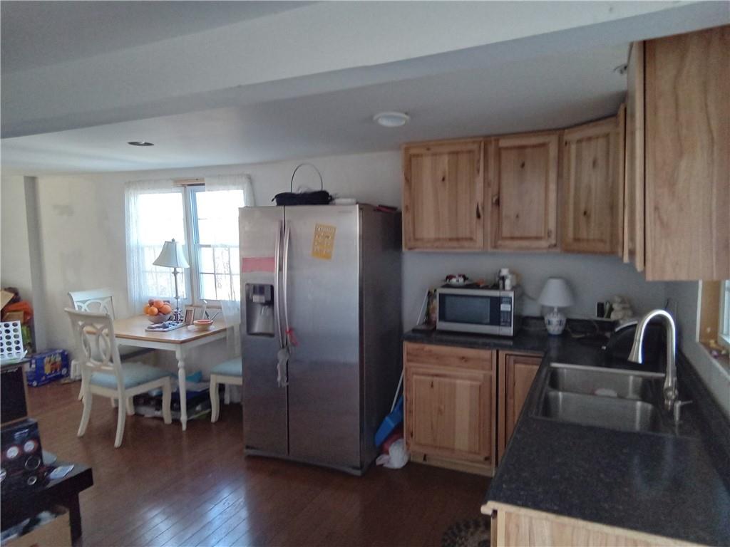 133 Slagle Avenue Butler, PA 16001 - Photo 6 of 14 a kitchen with stainless steel appliances granite countertop a refrigerator stove microwave and wooden floor