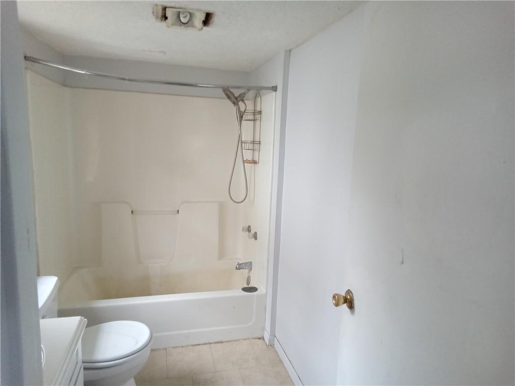 133 Slagle Avenue Butler, PA 16001 - Photo 9 of 14 a bathroom with a shower a toilet and a sink