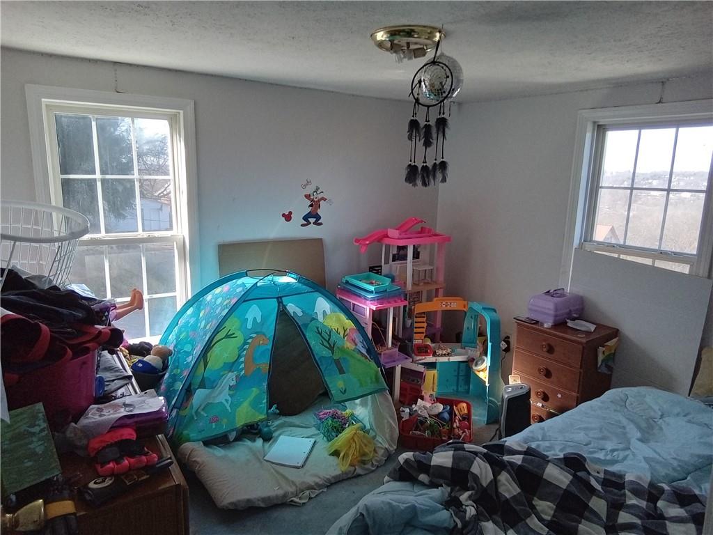 133 Slagle Avenue Butler, PA 16001 - Photo 10 of 14 a bedroom with a bed and windows