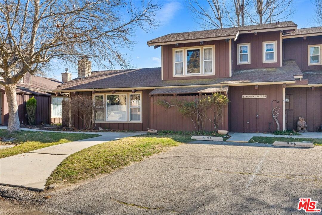 57 Meadow Lakes Drive Tehachapi, CA 93561 - Photo 3 of 26 a front view of a house with a yard and garage
