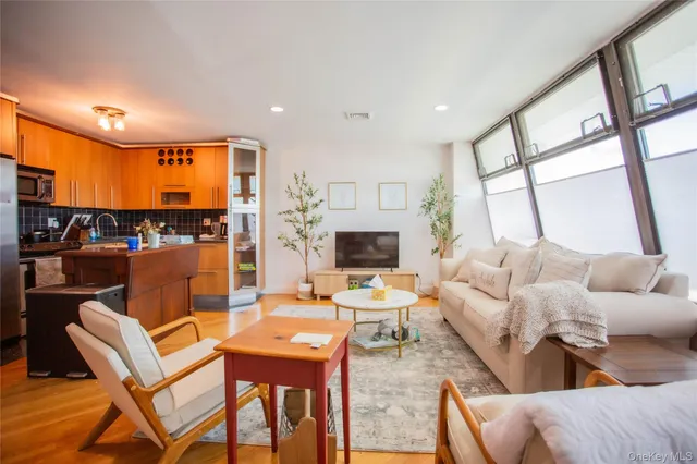 a living room with fireplace furniture and a large window