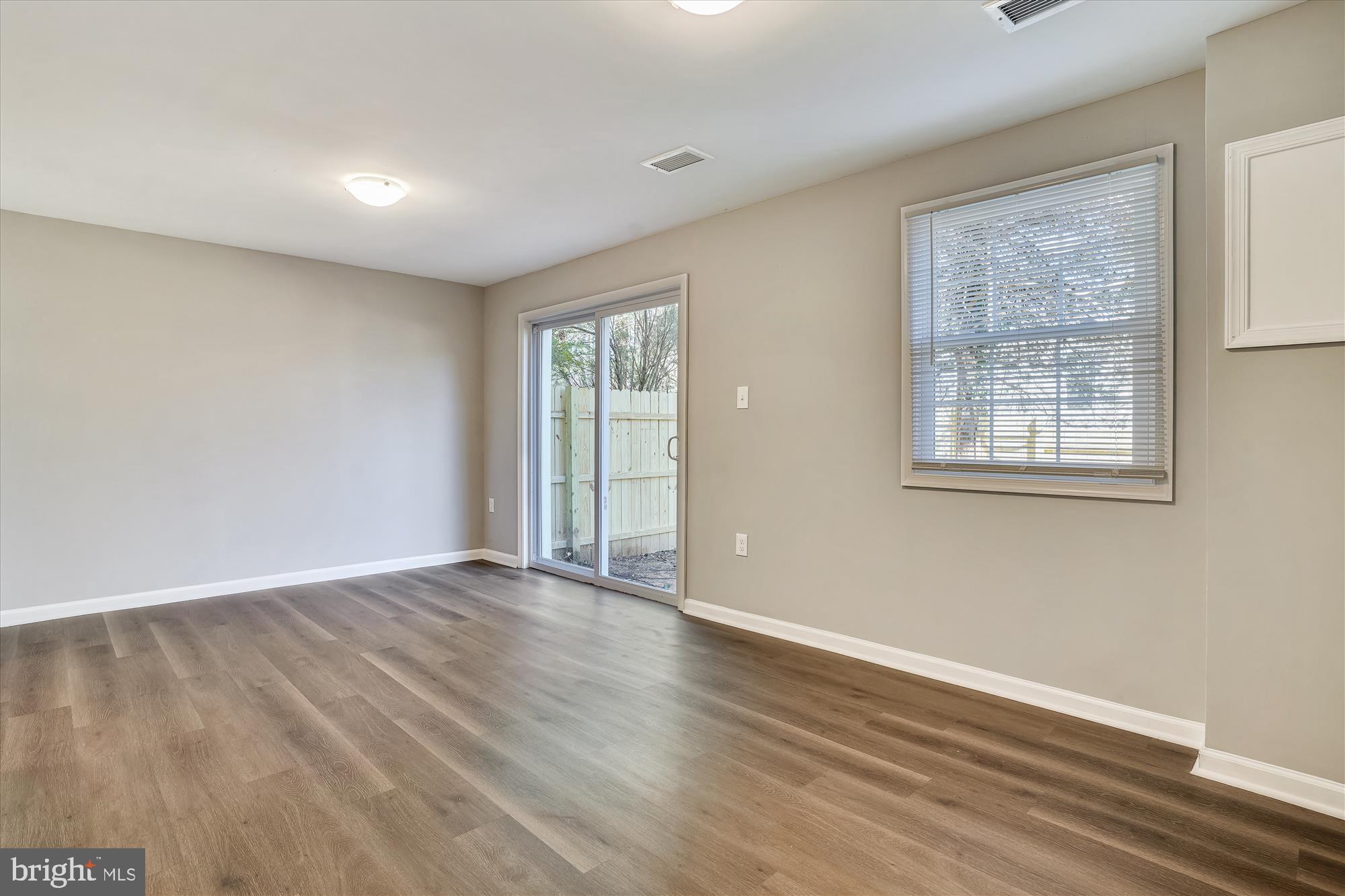 9202 Sprucewood Road Burke, VA 22015 - Photo 20 of 21 a view of an empty room with wooden floor and a window