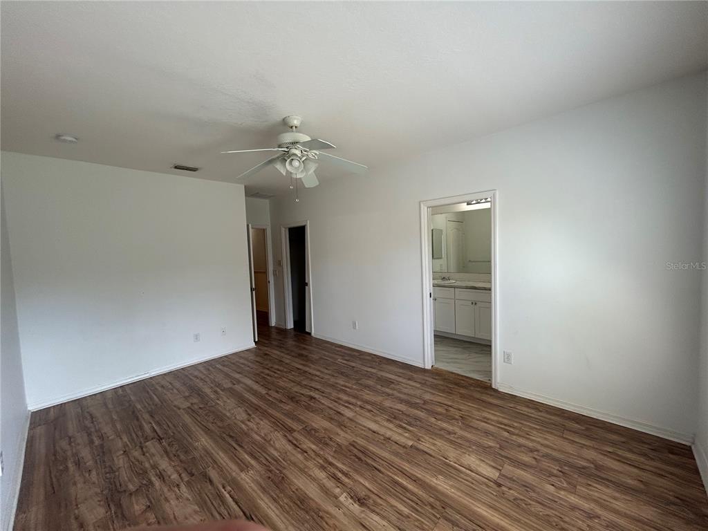3121 Capri Isle Way Orlando, FL 32835 - Photo 13 of 37 a view of an empty room with wooden floor
