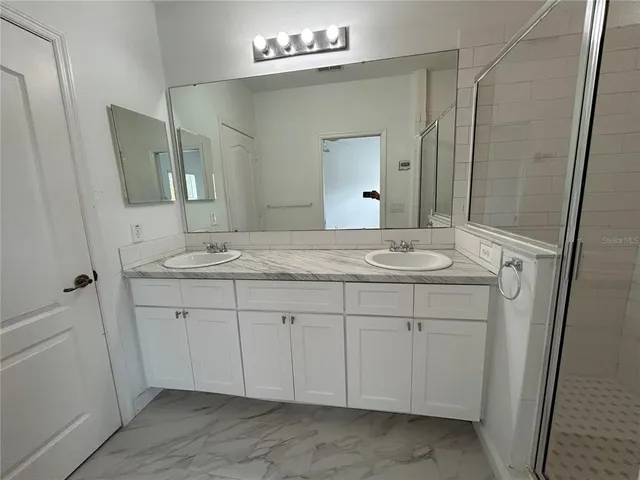 a bathroom with a sink and a mirror