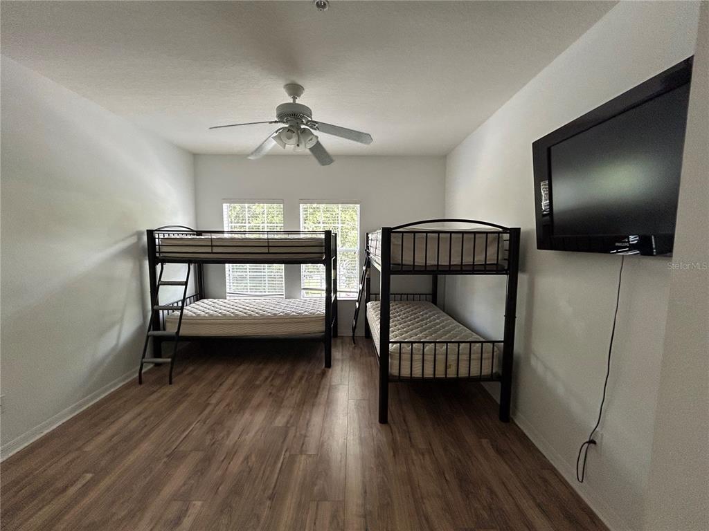 3121 Capri Isle Way Orlando, FL 32835 - Photo 18 of 37 a bedroom with a bed and a chandelier