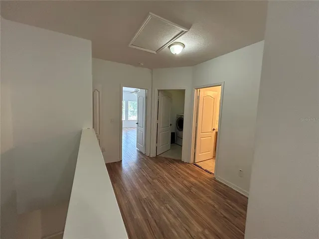 a view of hallway with wooden floor