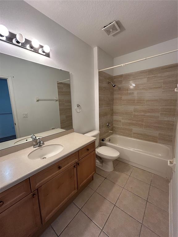3121 Capri Isle Way Orlando, FL 32835 - Photo 22 of 37 a bathroom with a granite countertop sink a toilet a mirror and shower