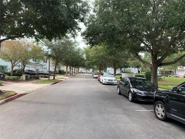 a living room with furniture a chandelier and a large window