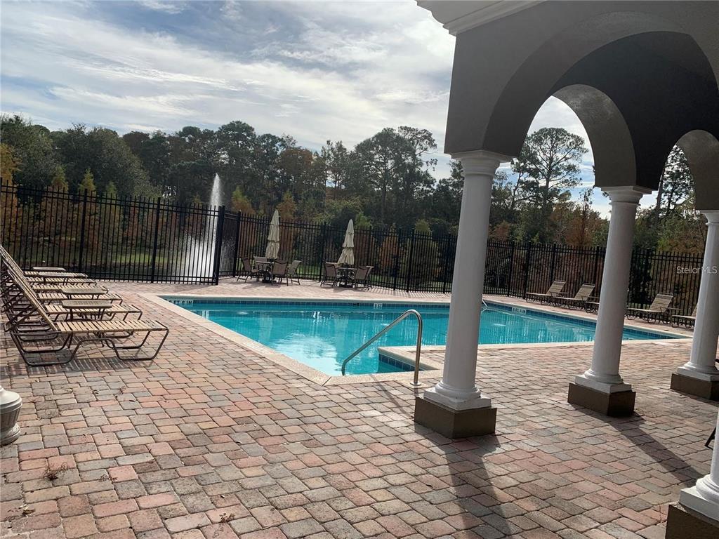 3121 Capri Isle Way Orlando, FL 32835 - Photo 26 of 37 a view of swimming pool with sitting area and slide