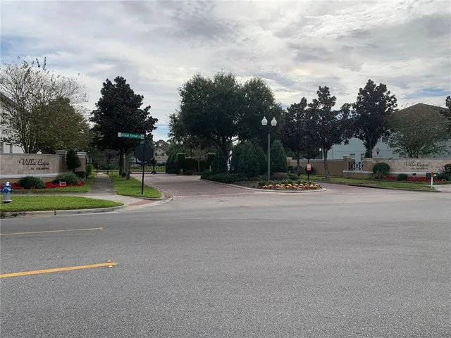 a view of a patio with a table and chairs and a barbeque with wooden fence