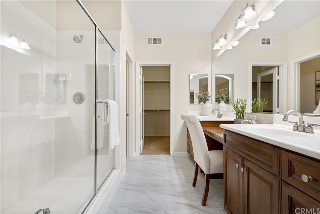 51 Secret Garden Irvine, CA 92620 - Photo 15 of 28 a spacious bathroom with a shower sink and mirror
