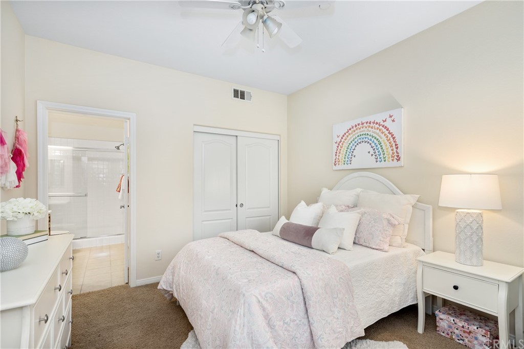 51 Secret Garden Irvine, CA 92620 - Photo 16 of 28 a bedroom with a bed and a chandelier