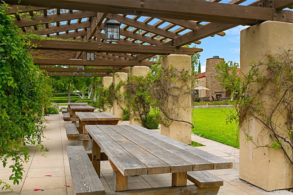 51 Secret Garden Irvine, CA 92620 - Photo 23 of 28 a wooden bench sitting in front of a building