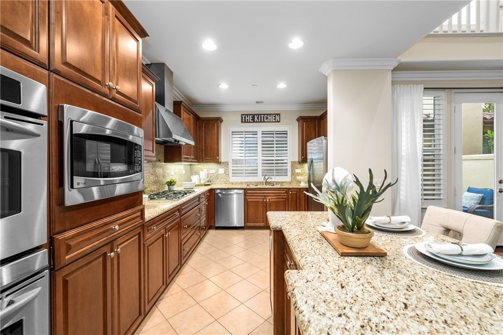 51 Secret Garden Irvine, CA 92620 - Photo 7 of 28 a large kitchen with stainless steel appliances granite countertop a stove a sink and a granite counter tops