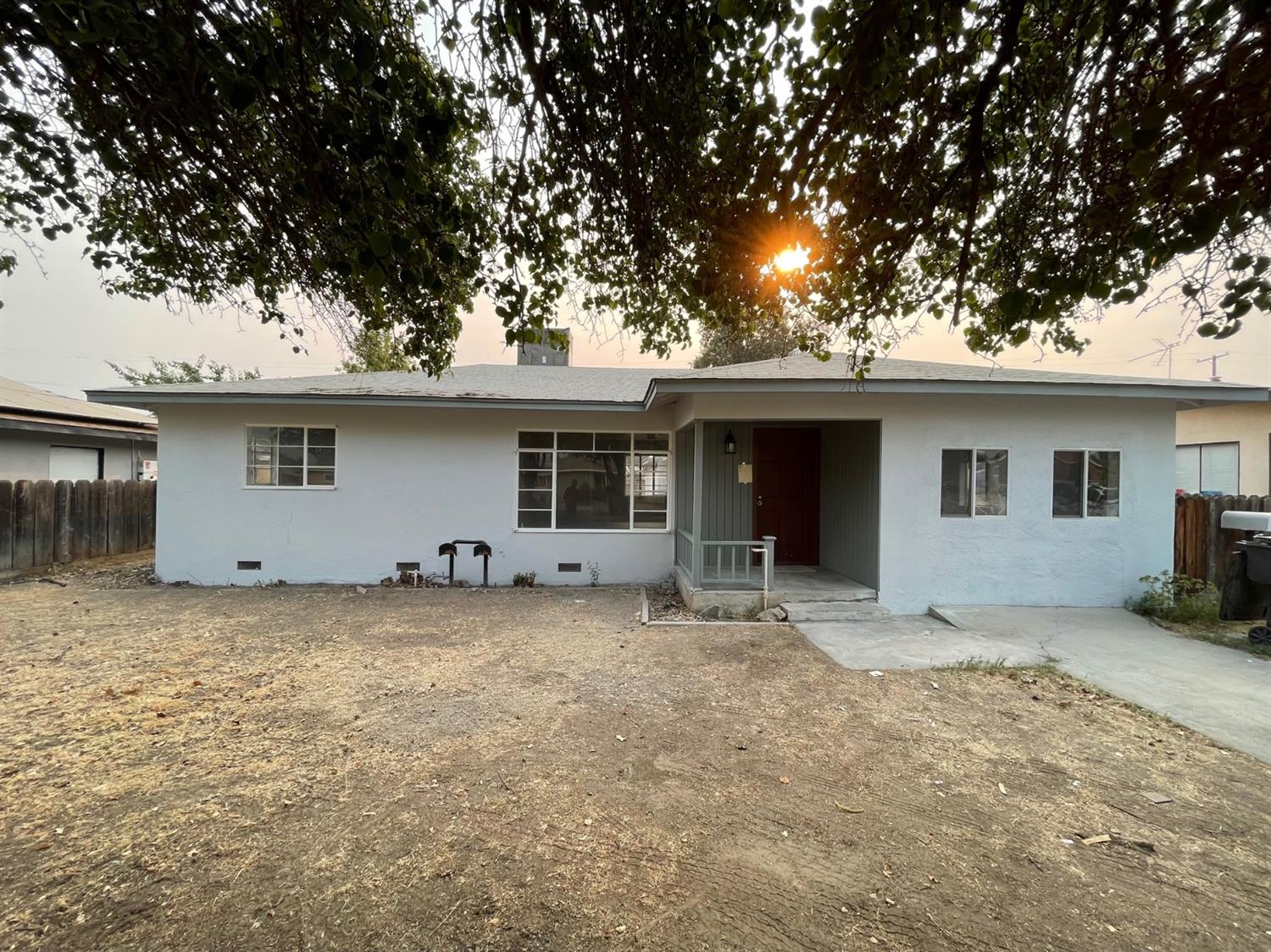 a view of a house with a tree in the background