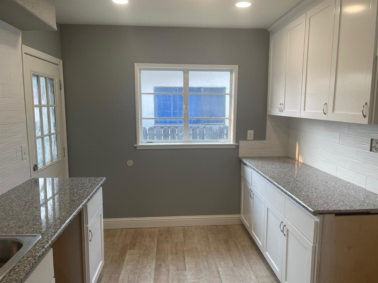 1246 South Klein Avenue Reedley, CA 93654 - Photo 4 of 10 a kitchen that has a microwave a sink and a stove in it