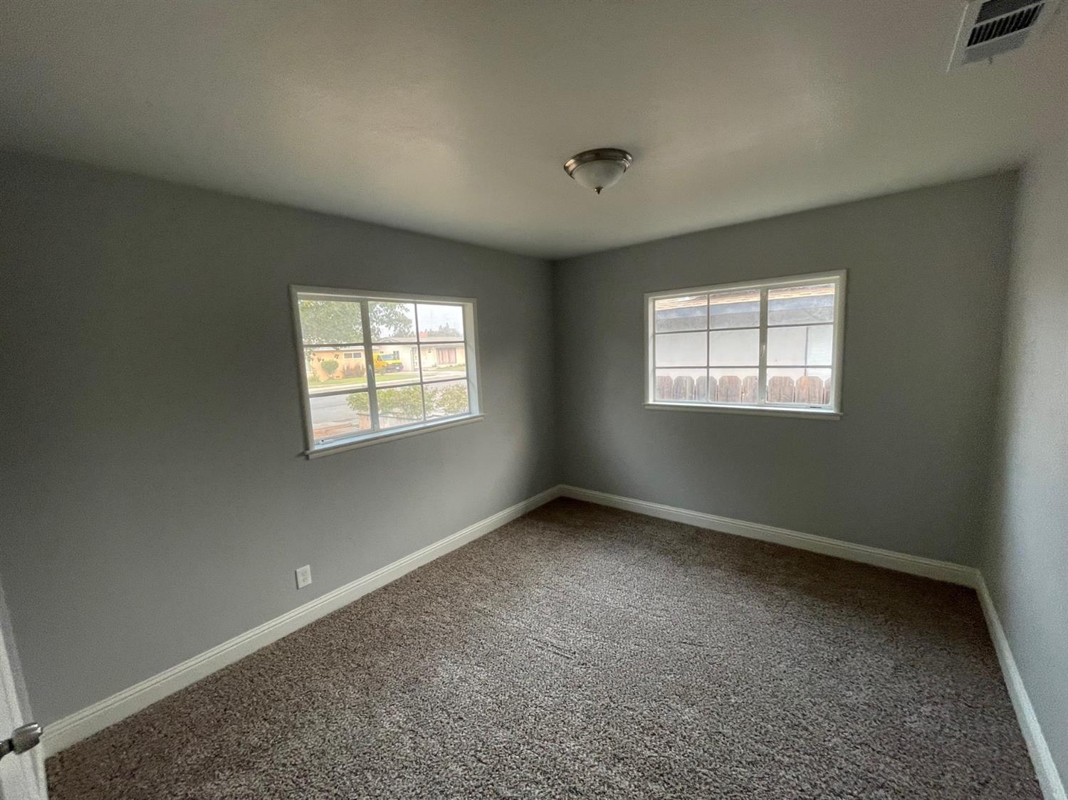 1246 South Klein Avenue Reedley, CA 93654 - Photo 7 of 10 an empty room with windows