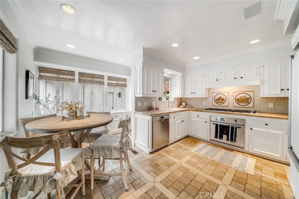 360 Diamond Street Laguna Beach, CA 92651 - Photo 12 of 36 a kitchen with a dining table cabinets appliances and a counter top space