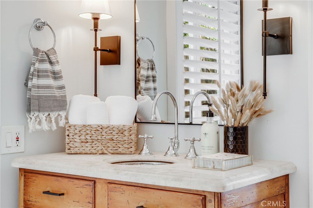 360 Diamond Street Laguna Beach, CA 92651 - Photo 16 of 36 a bathroom with a double vanity sink and a mirror