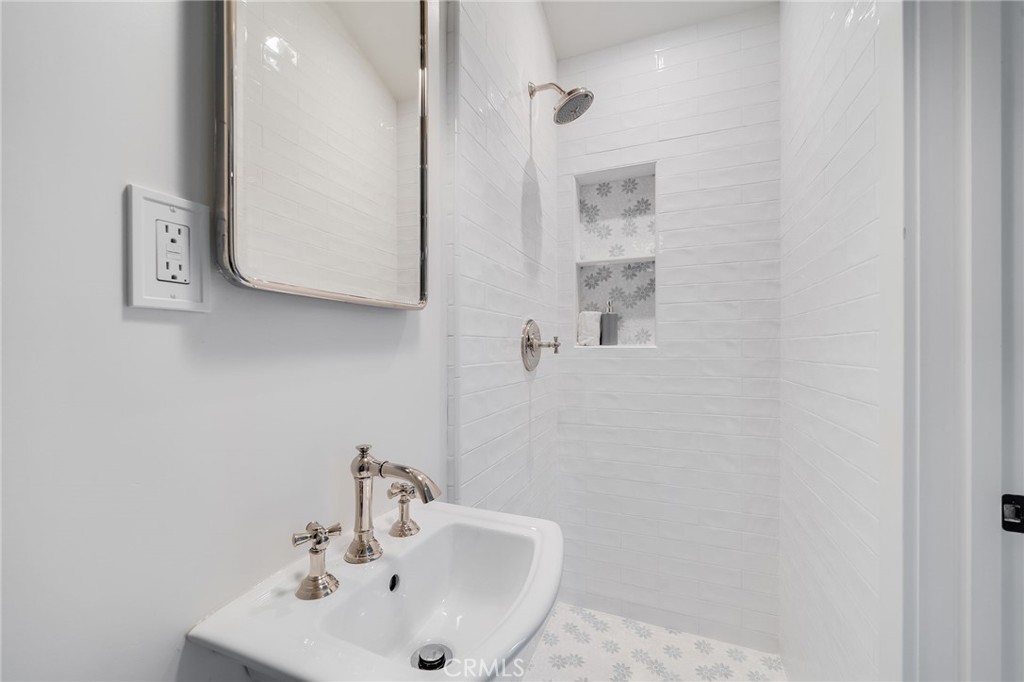 360 Diamond Street Laguna Beach, CA 92651 - Photo 27 of 36 a bathroom with a sink a mirror and shower