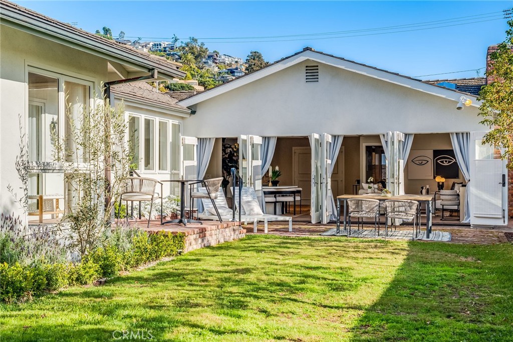 360 Diamond Street Laguna Beach, CA 92651 - Photo 28 of 36 a patio with table and chairs and potted plants