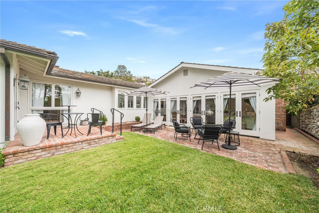 360 Diamond Street Laguna Beach, CA 92651 - Photo 31 of 36 a view of a house with patio and a garden