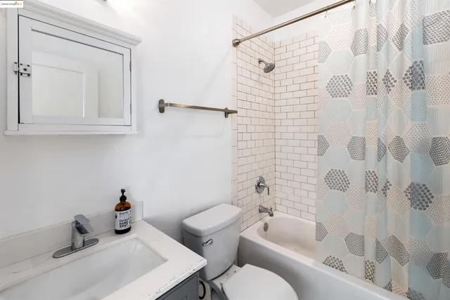 a view of a hallway with wooden floor and windows